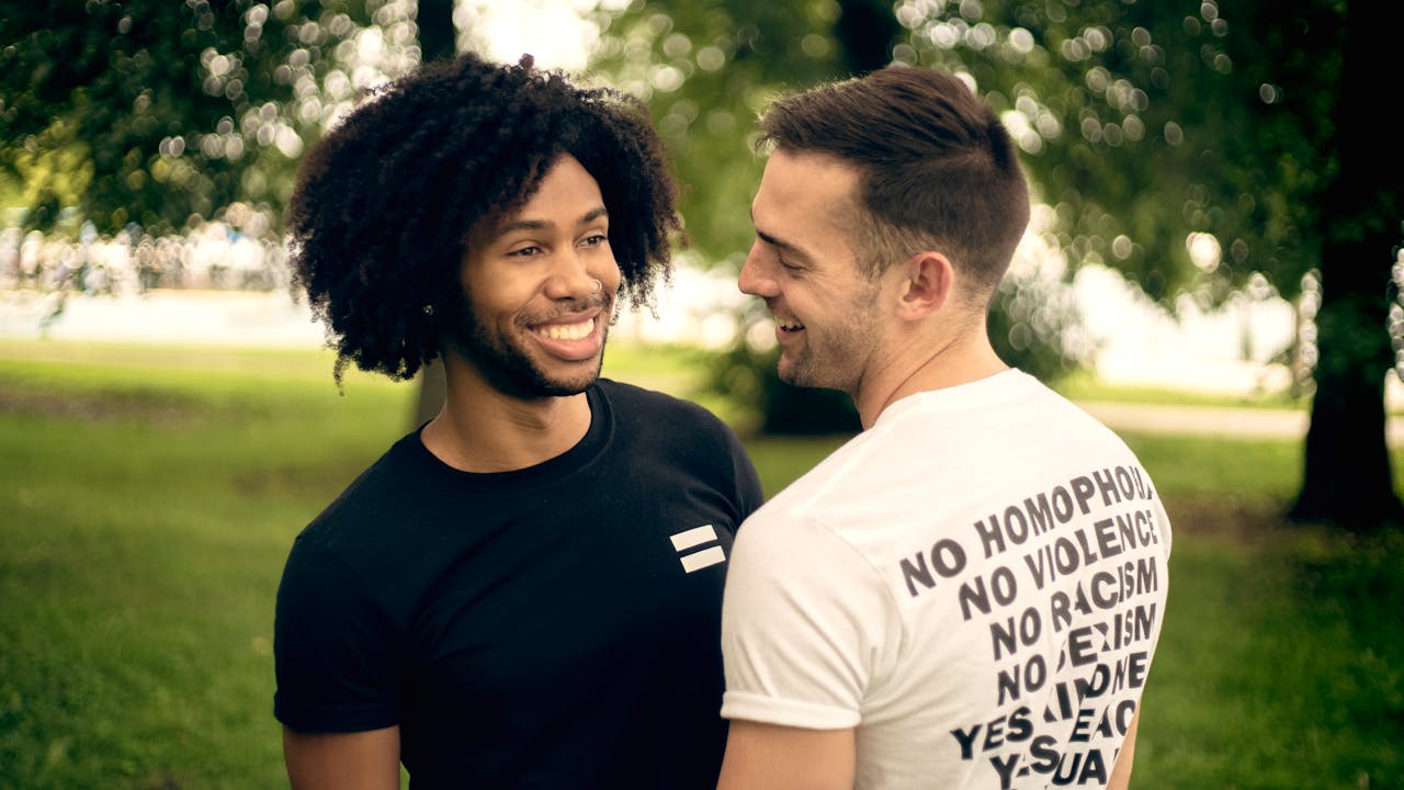 A happy couple enjoys a moment together in a Chicago park, celebrating love and equality.